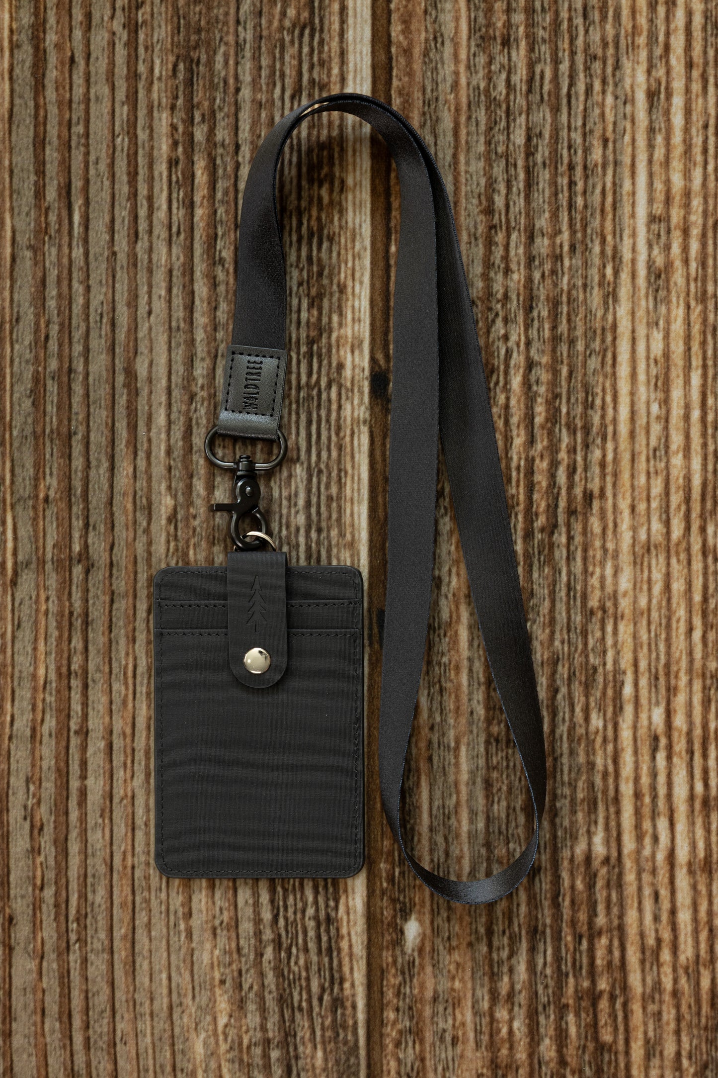 Black Neck Lanyard attached to a black textured canvas ID badge holder with a snap closure