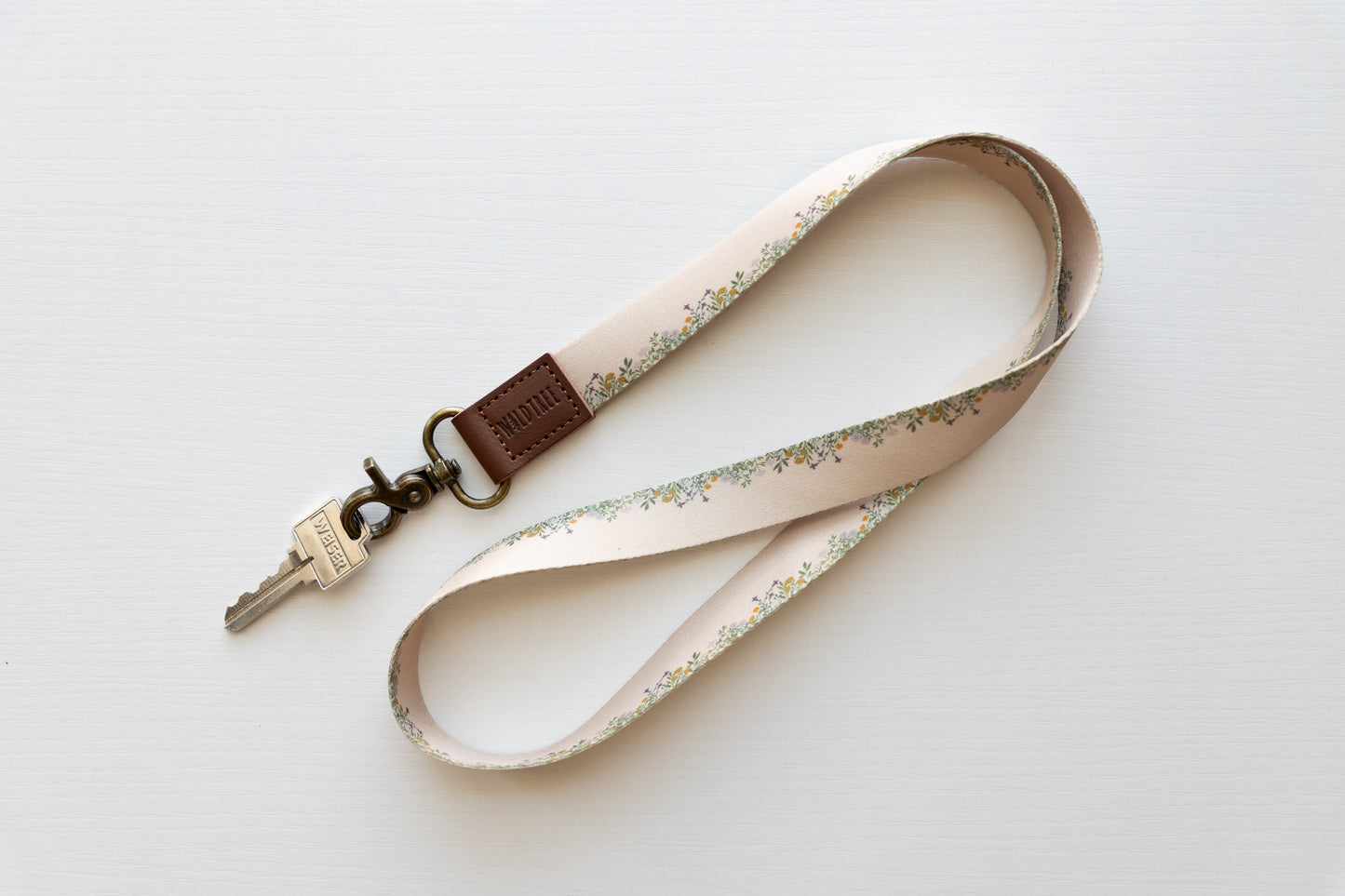 floral printed tan lanyard on white background