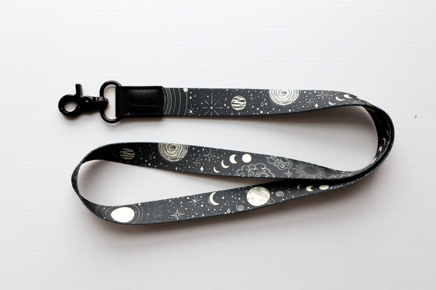 Black lanyard with Sun, moon, and stars pattern with black leather end with black hook