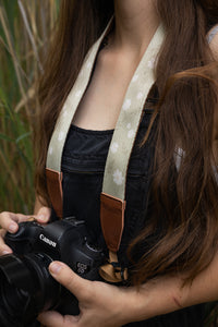 Women with wildtree daisy camera strap around neck holding canon camera