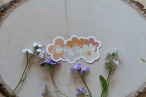 Grow Wild Retro Sticker displaying the words "Grow Wild" with retro flowers in background