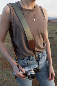 Woodland Green camera strap across women's shoulder