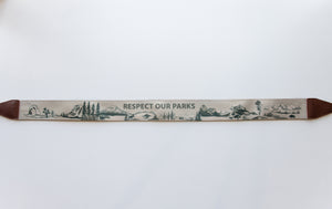 Wildtree Respect our parks national park camera strap attached to film camera