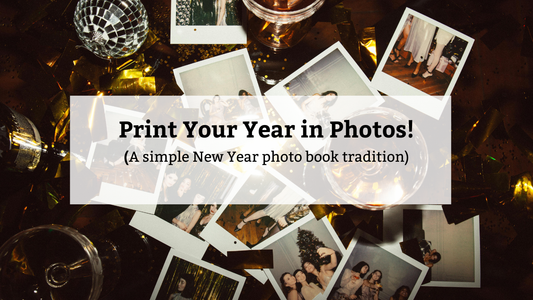 Overlay text reads "Print Your Year in Photos! (A simple New Year photo book tradition)" over a dark, flat lay of scattered instant photos, gold confetti, a disco ball, and champagne glasses.