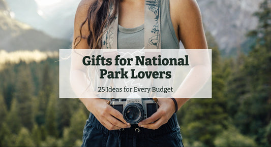 Woman in a forest holding a film camera on a Wildtree national park camera strap, with the title Gifts for National Park Lovers: 25 Ideas for Every Budget