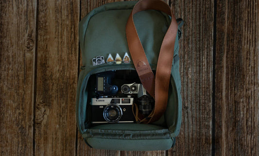 backpack with pins, cameras and wildtree camera strap