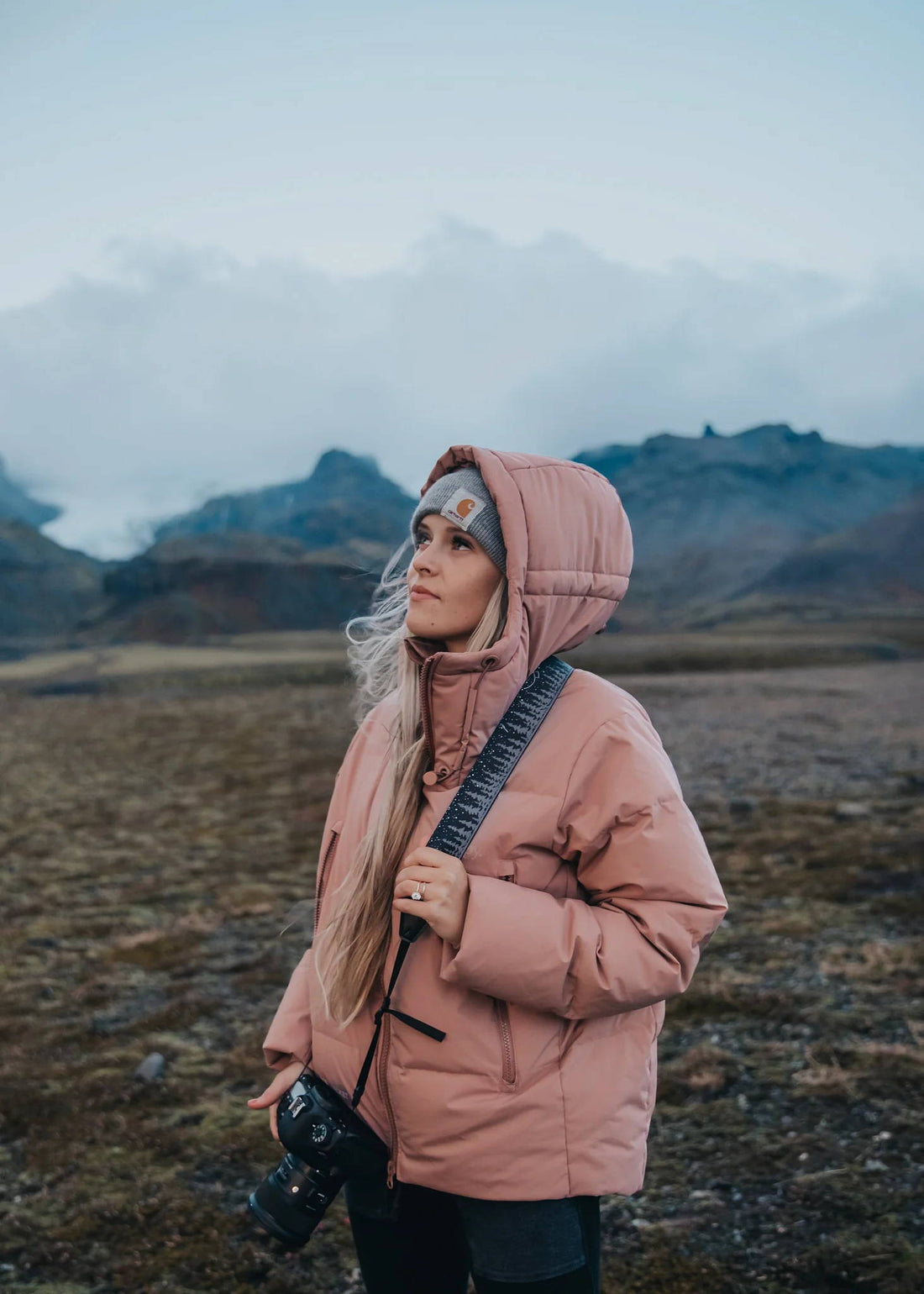 women wearing pink coat and wildtree camera strap