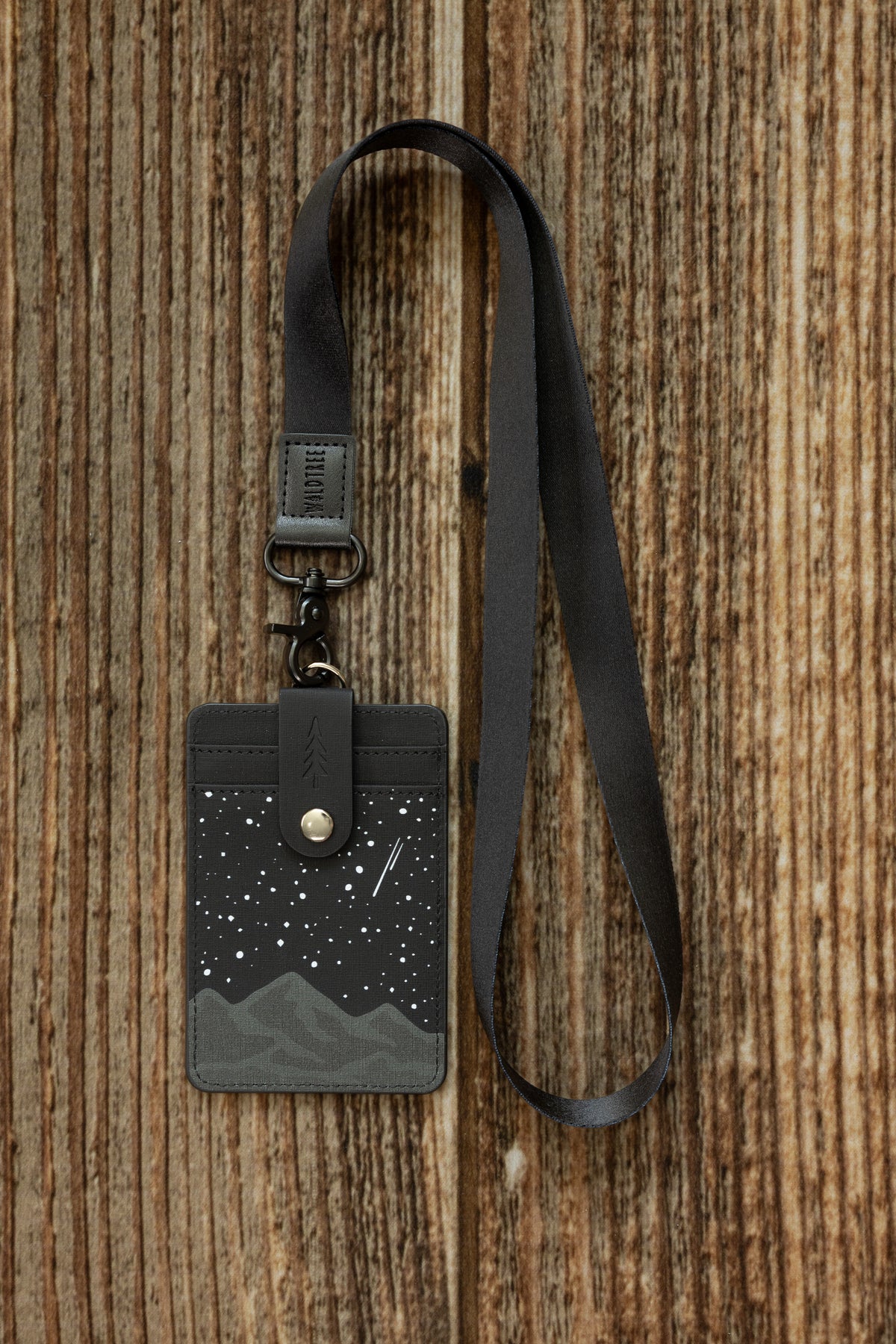 Black Neck Lanyard attached to a dark gray canvas ID card holder printed with a starry night mountain design