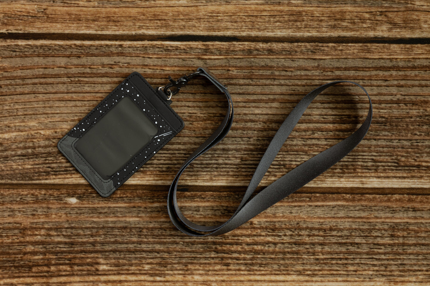 Black Neck Lanyard attached to a black leather ID badge holder with a clear window