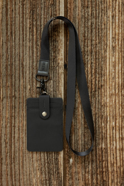 Black Neck Lanyard attached to a black textured canvas ID badge holder with a snap closure