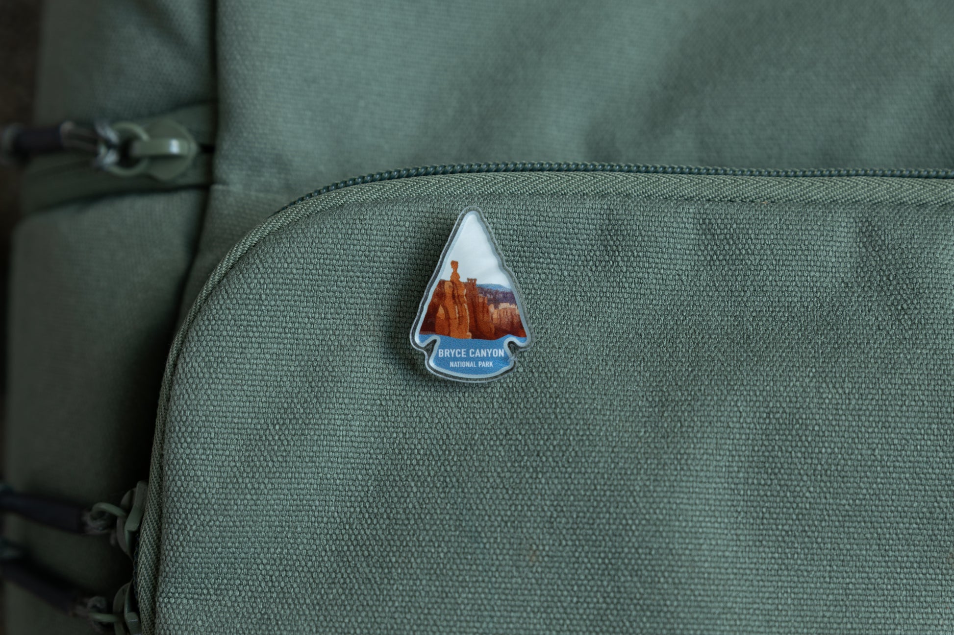 Bryce Canyon acrylic pin on green backpack 