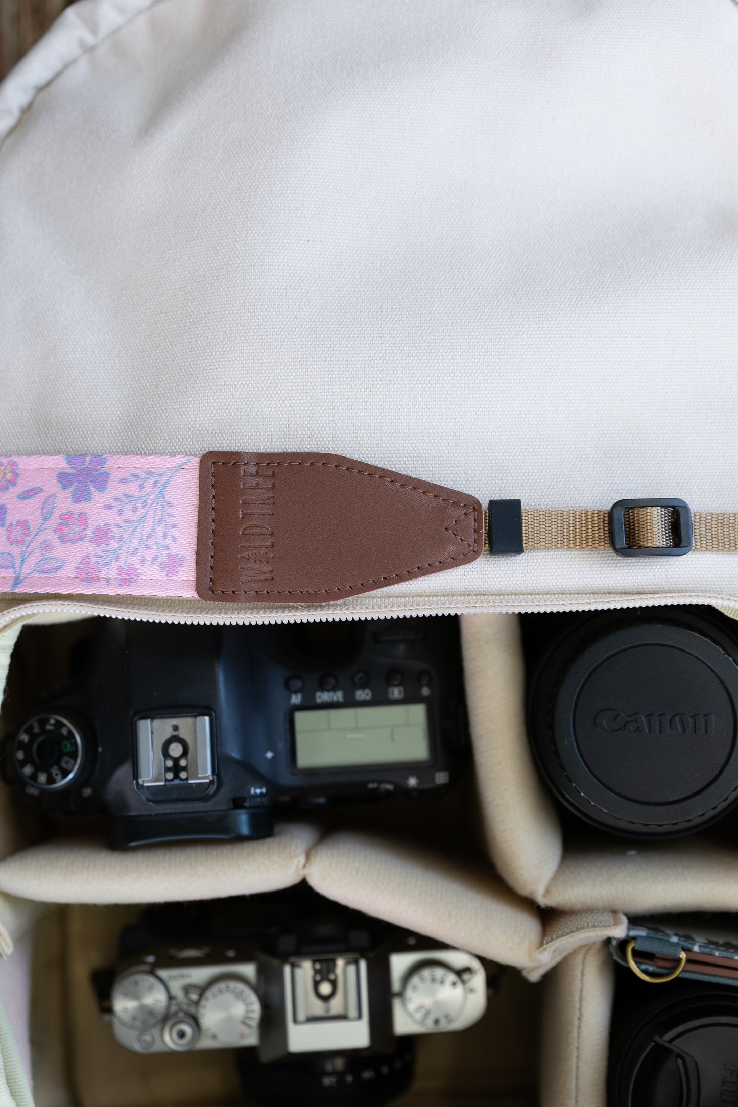 highlighting the close-up texture of the spade-shaped brown leather endpoint connector with perimeter stitching and the embossed Waldtree logo against a white studio background.