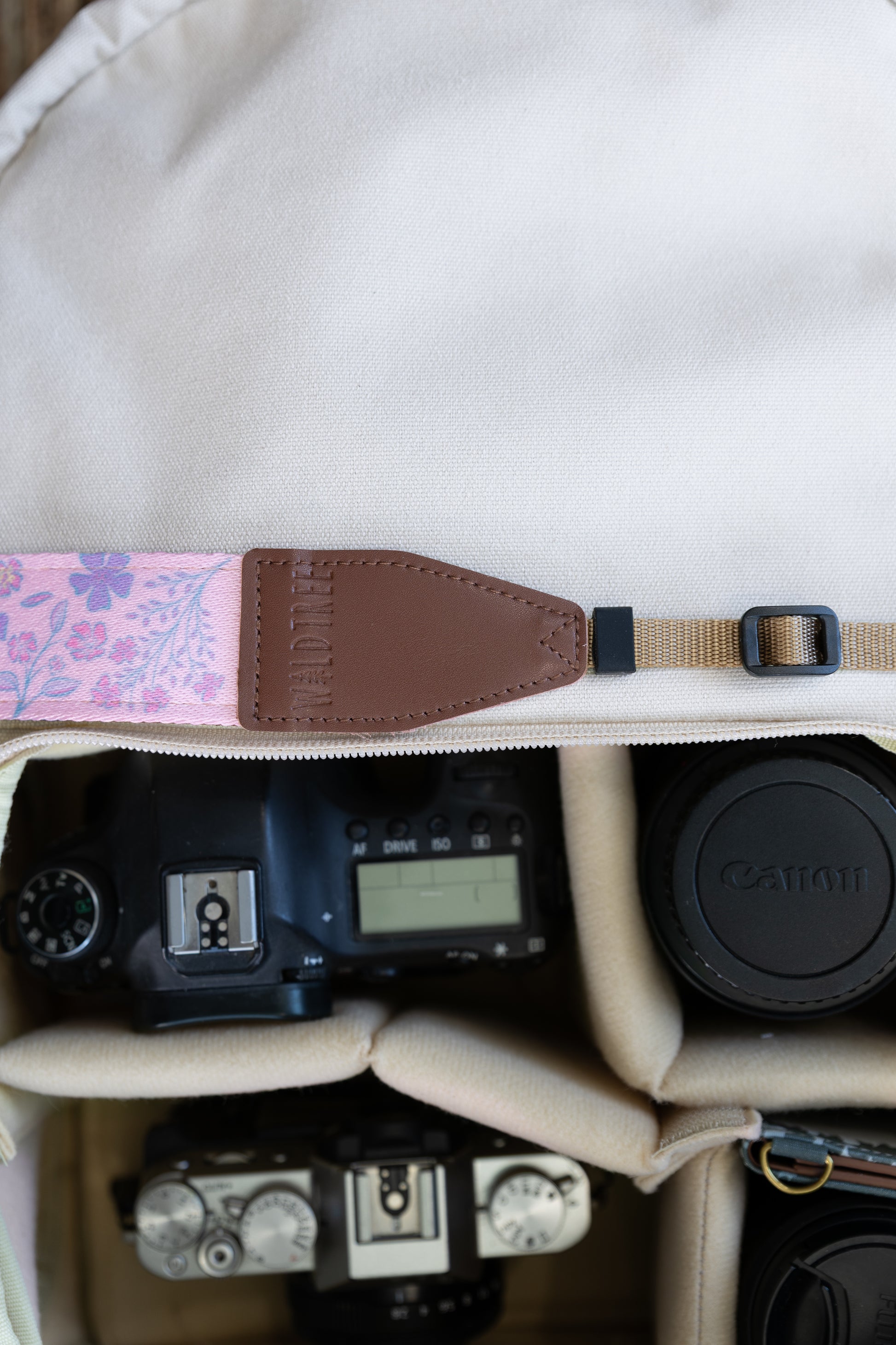 highlighting the close-up texture of the spade-shaped brown leather endpoint connector with perimeter stitching and the embossed Waldtree logo against a white studio background.