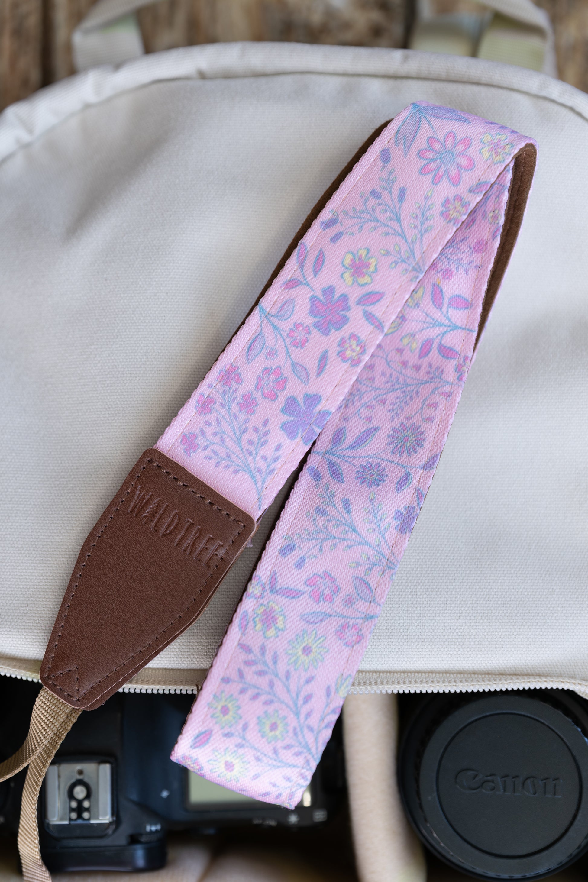 highlighting the close-up texture of the spade-shaped brown leather endpoint connector with perimeter stitching and the embossed Waldtree logo against a white studio background.