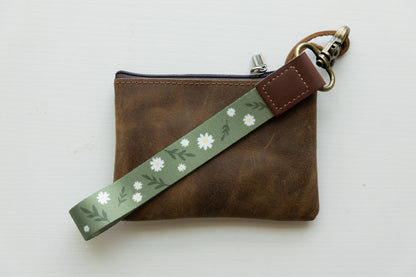 Daisy Wristlet keychain attached to brown leather wallet