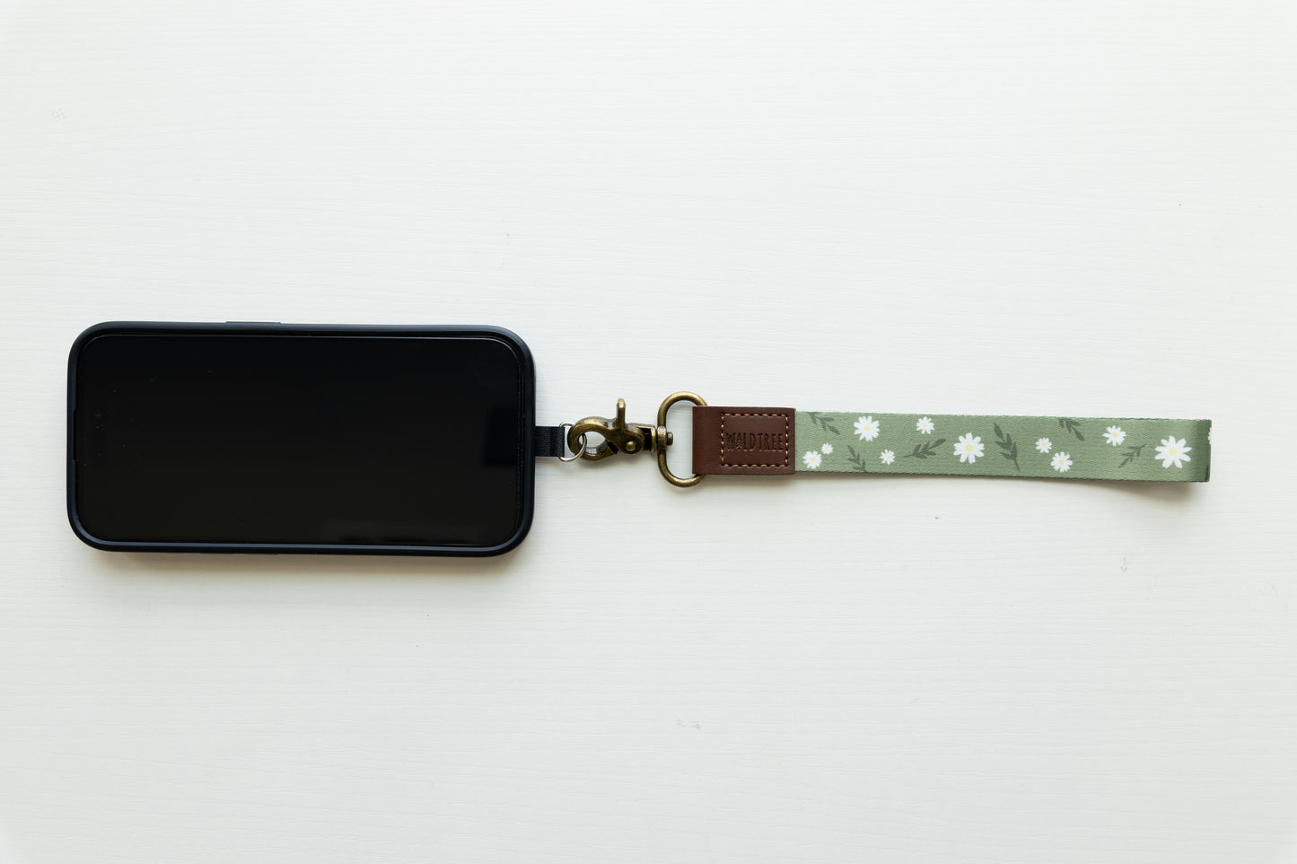 Daisy Wristlet keychain attached to phone