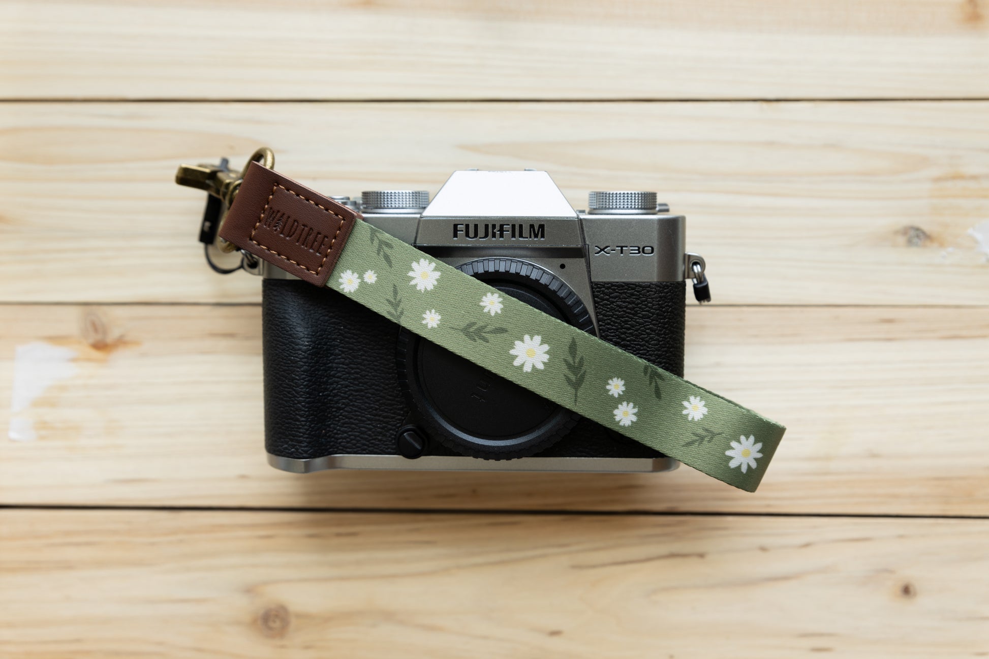 Daisy Wristlet keychain attached to fujfilm camera