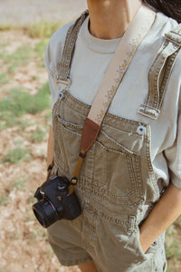 women wearing Flower Field Tan Camera strap crossbody