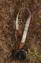 Load image into Gallery viewer, Flower Field Tan Camera strap playing in tall grass connected to canon camera - Best camera strap for canon camera.
