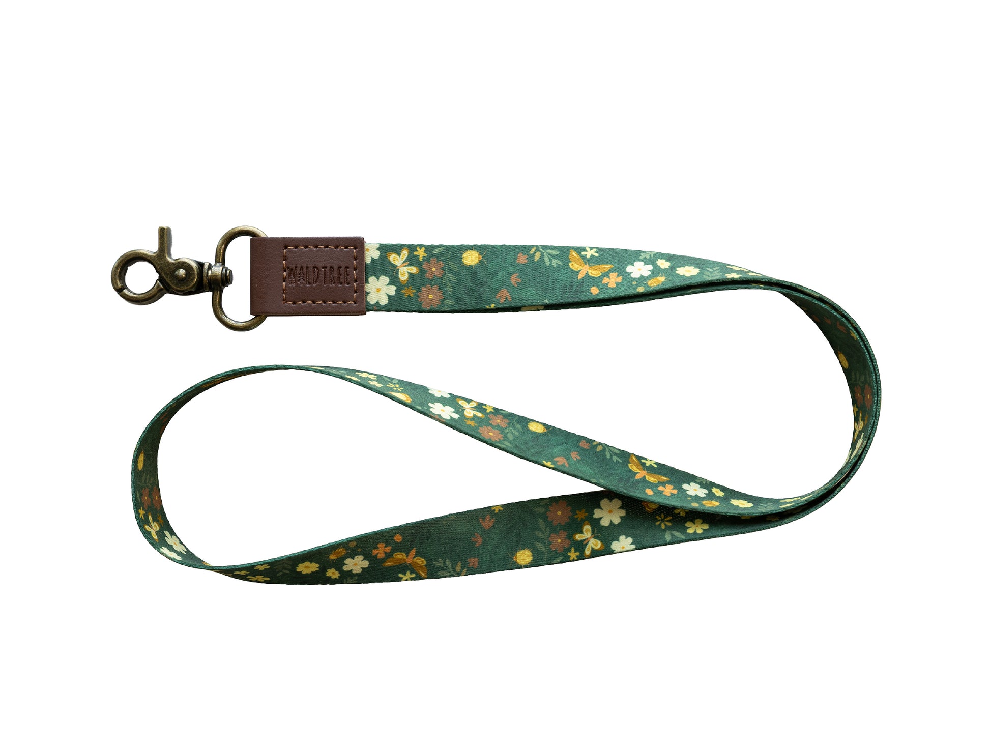 Flat lay of the Flutter & Fern neck lanyard on a white background, showing the full dark green fabric strap printed with white daisies, small brown flowers, and gold butterflies, paired with a brown vegan-leather card holder with a clear ID window attached by a brown leather tab and bronze swivel clasp.