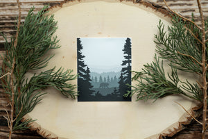 A bear walking in the forest between two big trees sticker