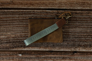 Wildtrees green pinetree keychain attached to brown leather wallet