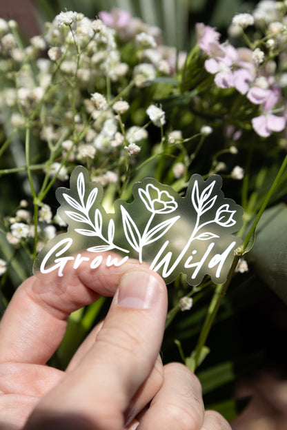 grow wild sticker with the words "grow wild" with flowers growing from the words