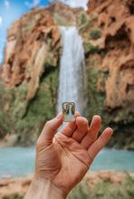 Load image into Gallery viewer, Havasu falls pin being held out in front of havasu fall havasupai indian reservation in the grand canyon
