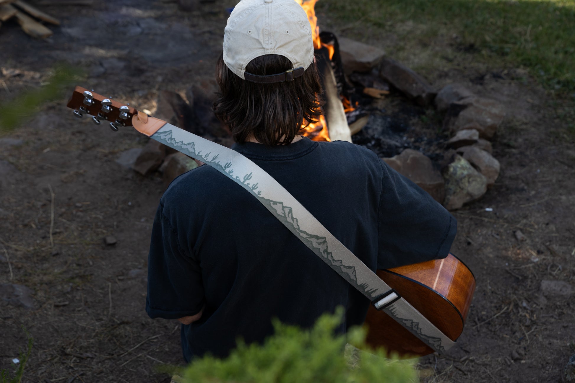 Landscape guitar strap Mountain trees and cactus design outside around a campfire playing guitar