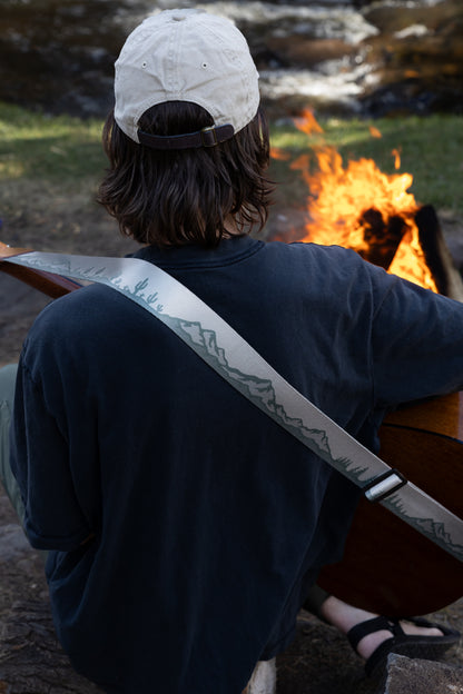 Landscape guitar strap Mountain trees and cactus design outside around a campfire playing guitar