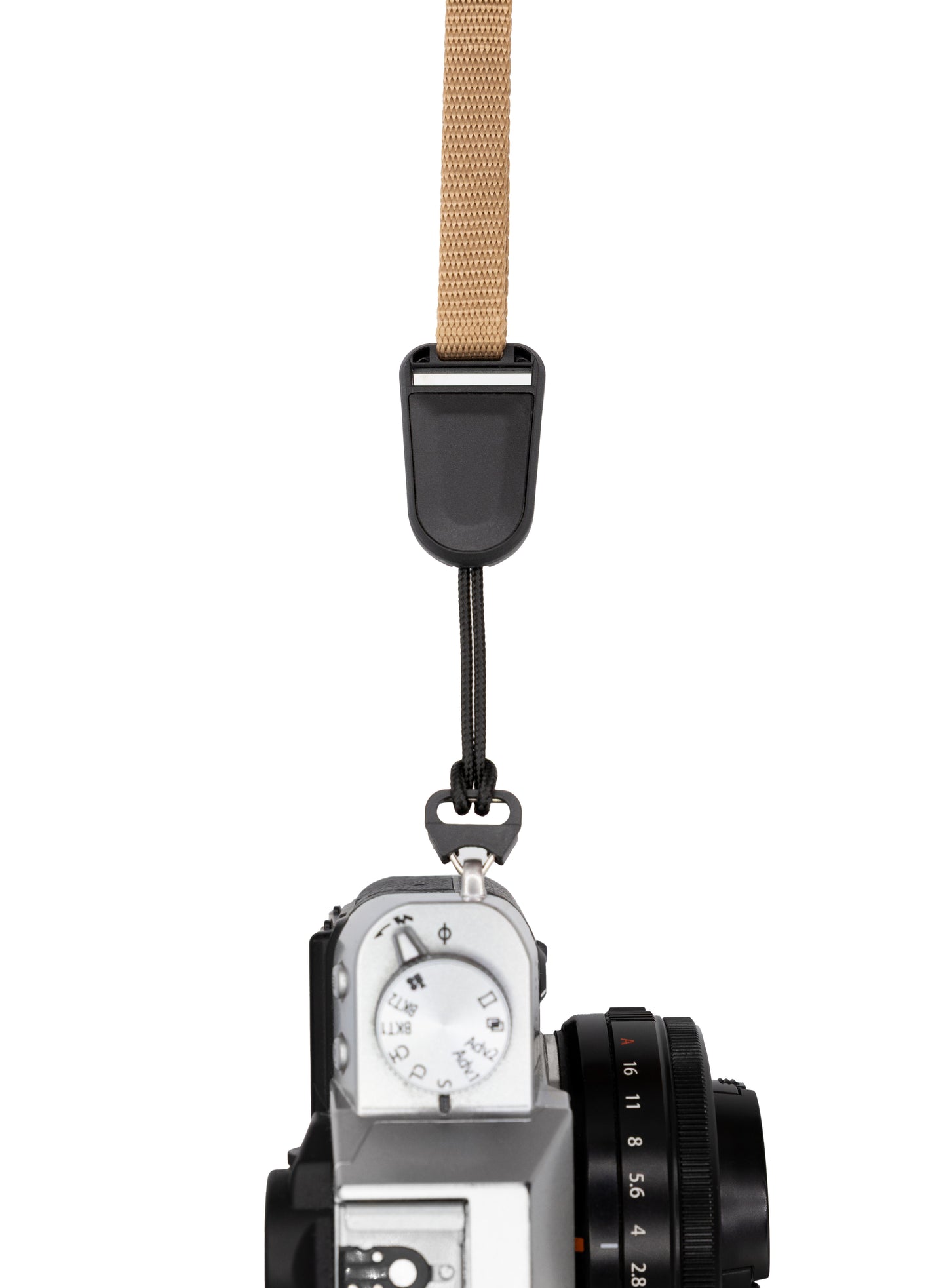 Photographer viewed from behind, holding a Canon camera by a wrist strap connected through a low-profile quick-release buckle adapter