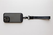 Load image into Gallery viewer, Black midnight mountain keychain attached to phone case
