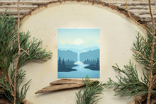 Load image into Gallery viewer, misty evening sticker featuring a calm river and waterfall. Deer by the riverbed
