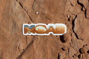 WIldtree Moab Utah Sticker laying on desert rocks
