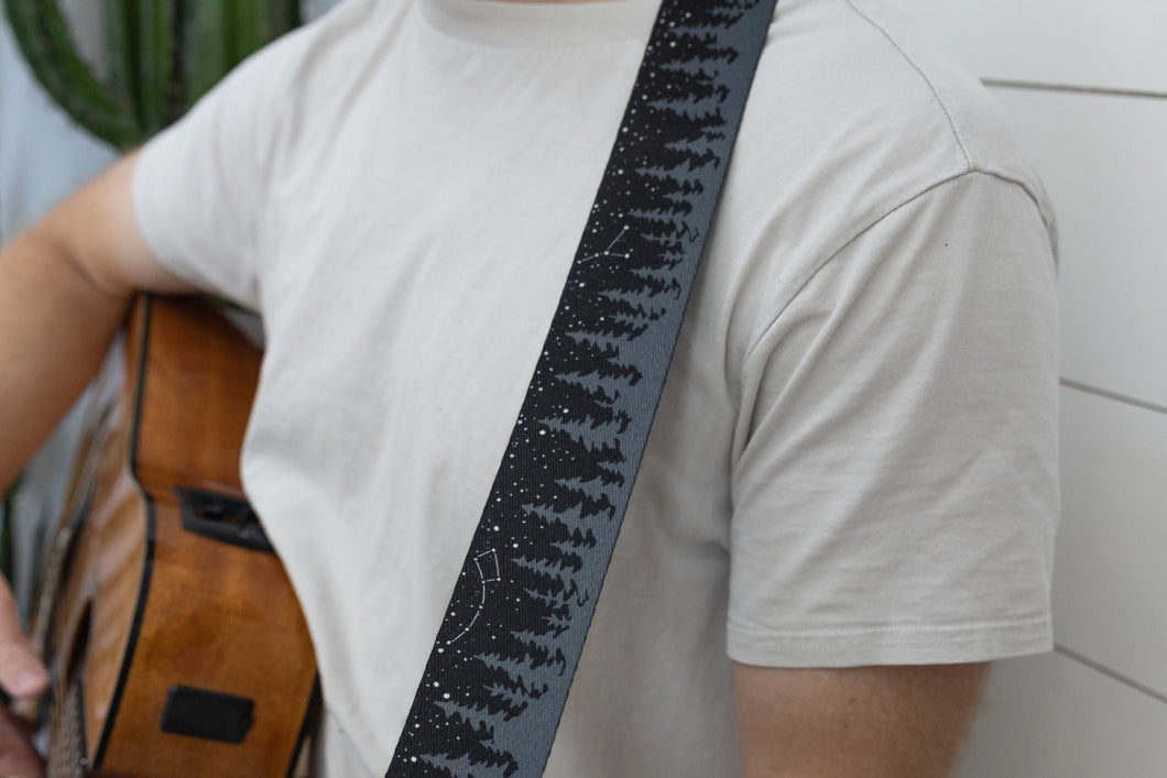 Black guitar strap with trees and stars