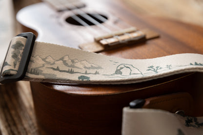 Close up of arches and grand teton national park printed on ukulele strap