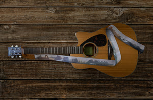 national park guitar strap attached to acoustic guitar