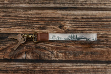 Load image into Gallery viewer, national park wristlet keychain laying on wood floor
