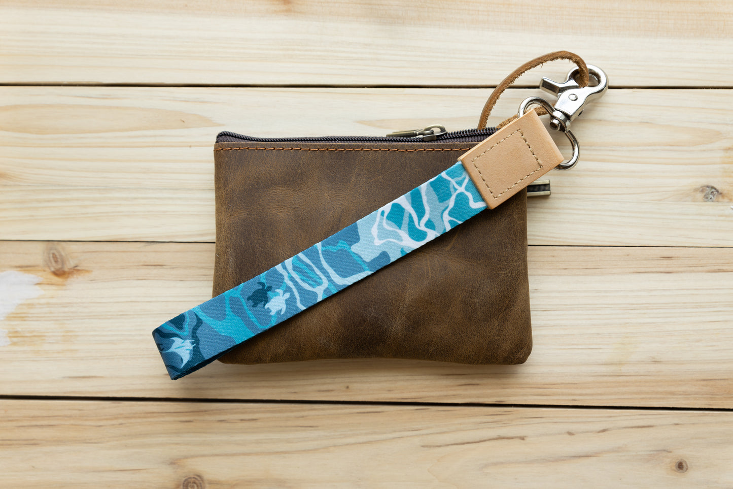 Ocean design wristlet keychain attached to brown leather wallet