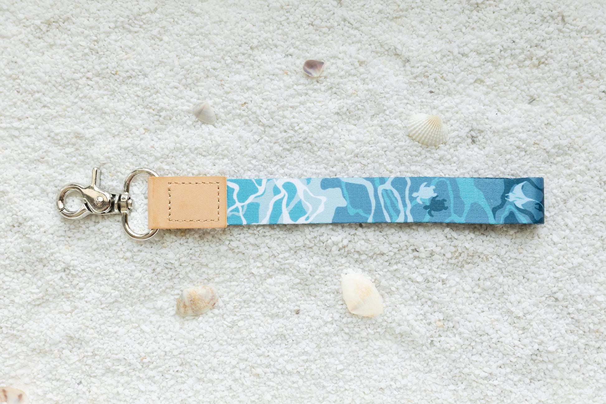 Ocean design wristlet keychain on white sand