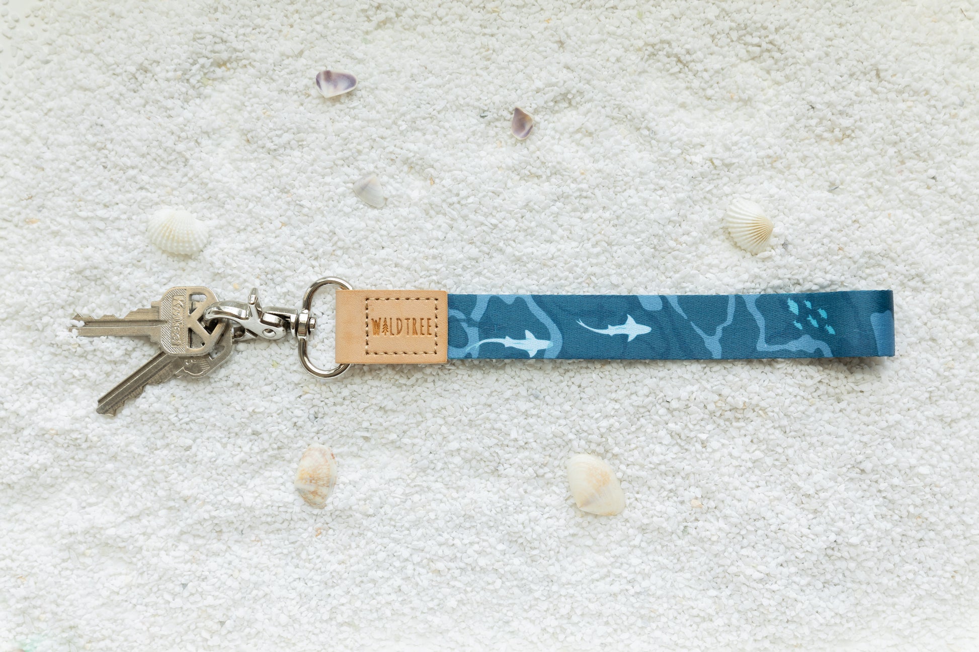 Ocean design wristlet keychain on white sand