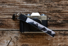 Load image into Gallery viewer, national park wristlet keychain black and white attached to small camera
