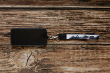 Load image into Gallery viewer, national park wristlet keychain black and white attached to phone
