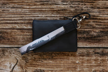 Load image into Gallery viewer, national park wristlet keychain black and white attached to black wallet
