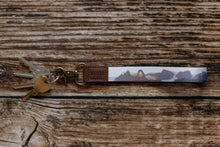 Load image into Gallery viewer, popular us national parks printed on wristlet keychain attached to keys
