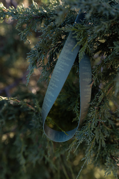 Pinetree printed lanyard keychain hanging from evergreen tree