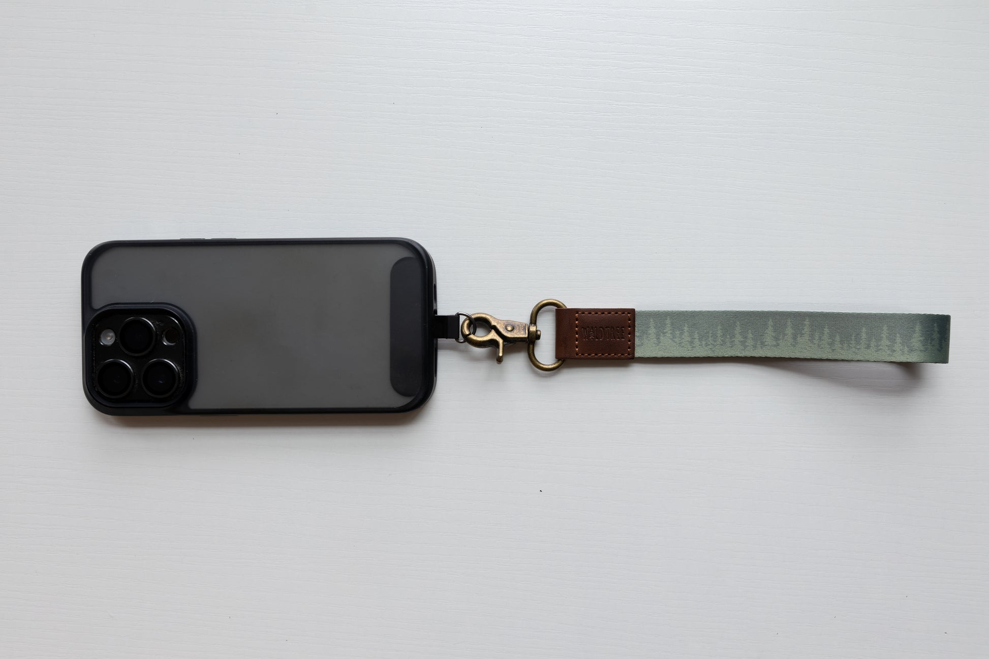 pinetree keychain attached to phone case