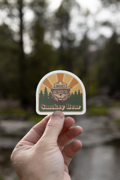 Smokey bear Retro Sticker being held up 