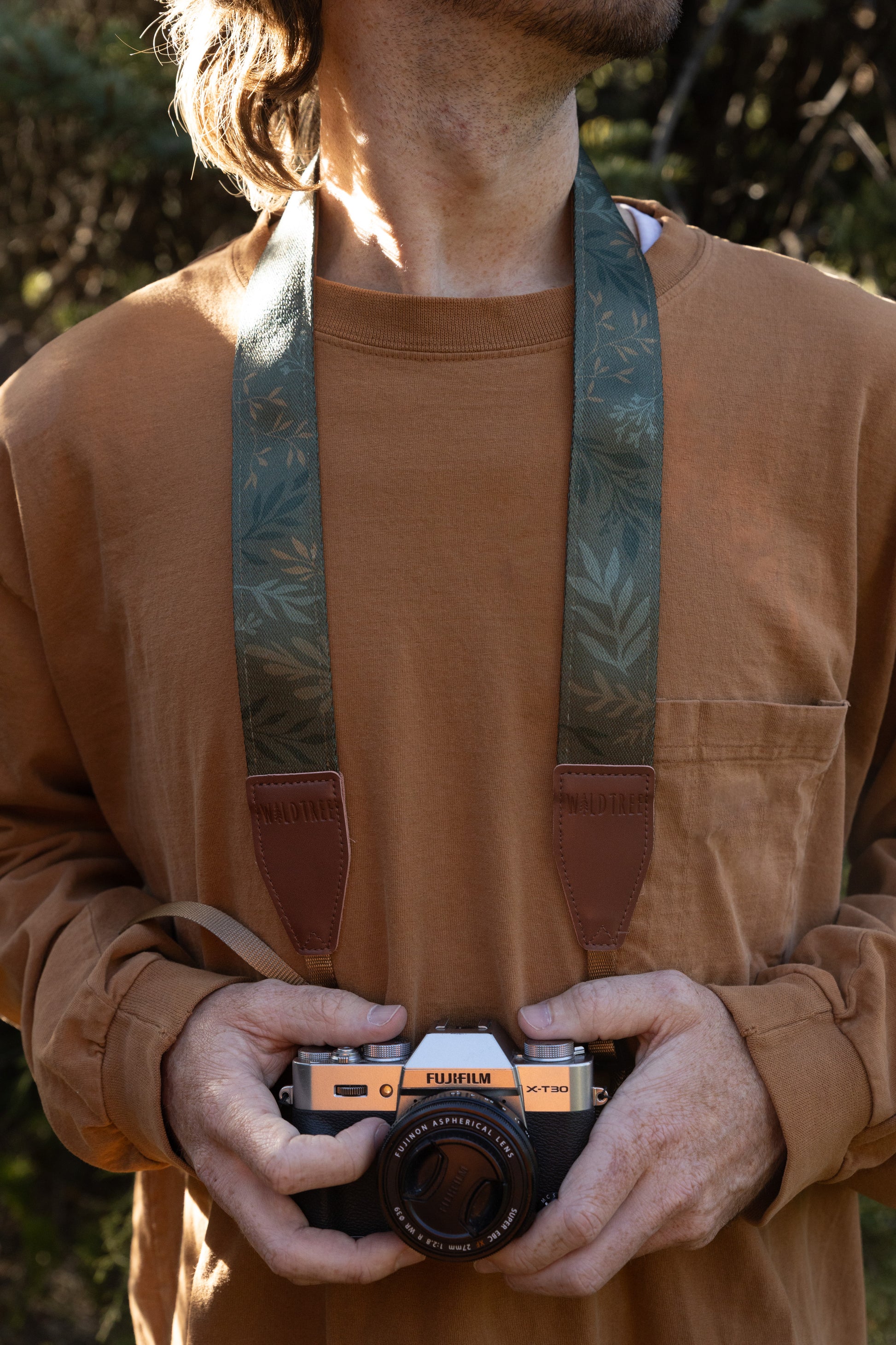 Close-up detail of a person wearing the WILDTREE "Silent Grove" strap, focusing on the branded vegan leather attachment point.
