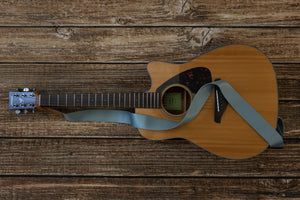 blue colored guitar strap attached to acoustic guitar